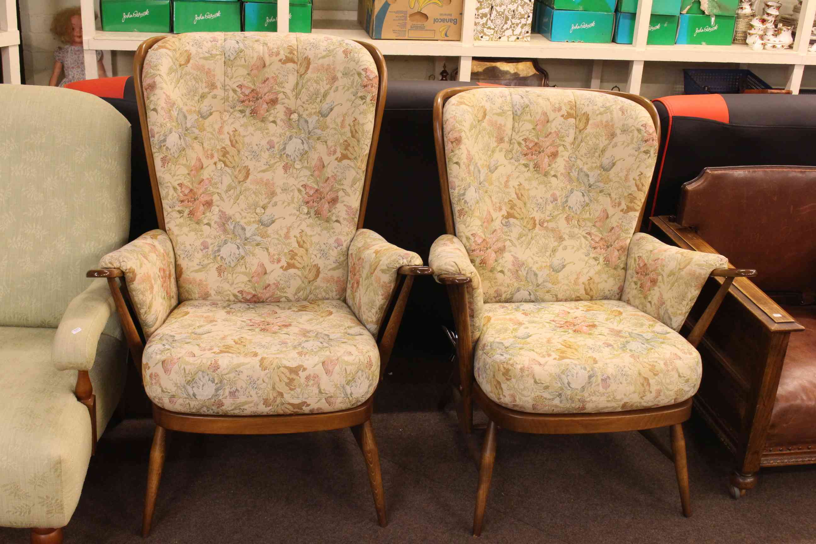 Pair Ercol armchairs in floral buttoned fabric.