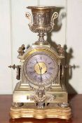 Ornate brass mantel clock with urn top and stand, 46cm high.