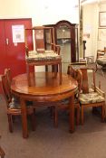 Oriental style rosewood oval extending dining table and two leaves together with eight matching