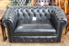 Black buttoned leather two seater Chesterfield settee.