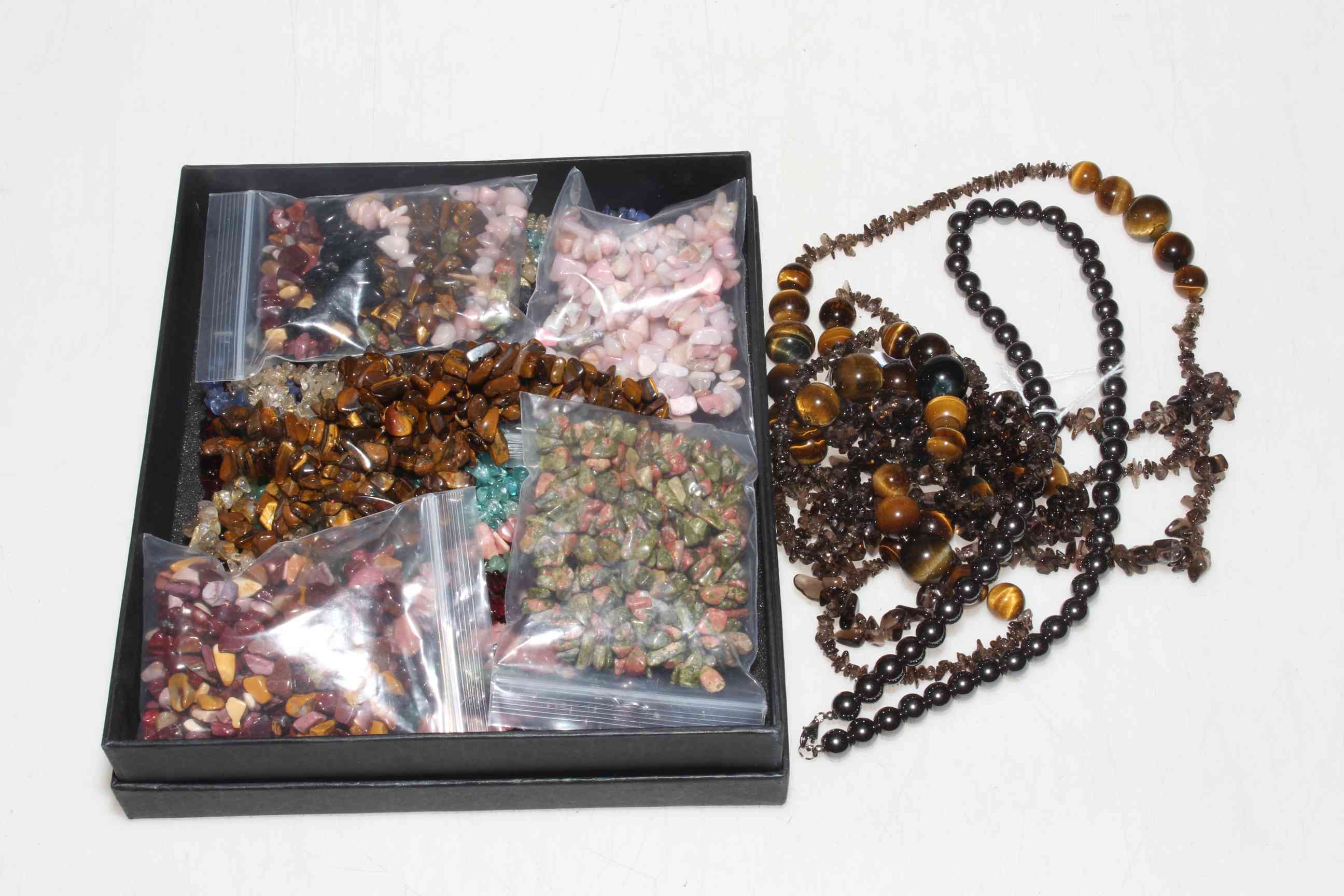 Necklaces and stones including Tigers Eye.