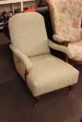 Open armchair in sage green fabric.