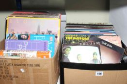 Two boxes of vinyl records, singles, books, picture and a carry case.