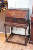 Antique oak slope front bible box on turned leg stand, 95cm by 65cm by 45cm.