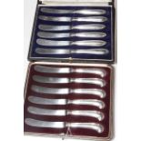 Two boxed sets of silver handled tea knives.