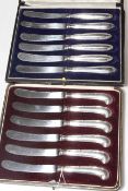 Two boxed sets of silver handled tea knives.