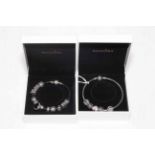 Two Pandora silver charm bracelets.