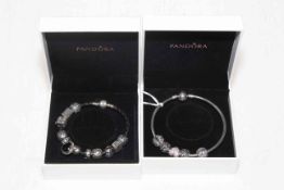Two Pandora silver charm bracelets.