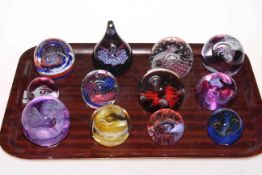 Twelve Caithness glass paperweights.