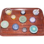 Ten Millefiori glass paperweights, mostly with John Deacons, Scotland, labels.