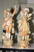 Pair of Continental porcelain figures with musical instruments in colourful costume, 57cm high.