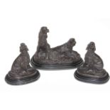 Set of three bronze spaniel sculptures, on marble bases, largest 21cm high, 27cm across.