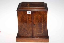 Victorian inlaid walnut table cabinet with two doors enclosing three drawers, 33cm high.