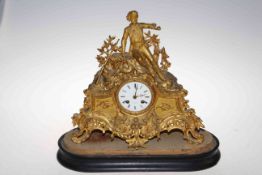 Ornate gilt metal mantel clock depicting a young boy, labelled Reid & Sons, Paris, 40cm high.