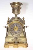 Ornate brass mantel clock with urn top and stand, 46cm high.