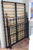 Victorian style black and brass double bedstead.