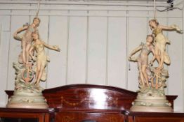 Pair of large painted metal figure lamps bearing musical players, 83cm high.