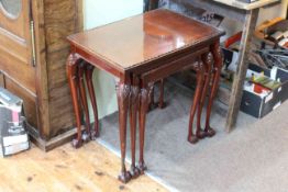 Nest of three glass topped occasional tables on ball and claw legs (largest 62cm by 63cm by 43cm).