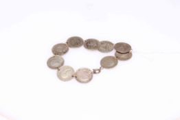 Silver sixpence bracelet with ten coins.