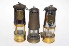 Three vintage miners lamps.