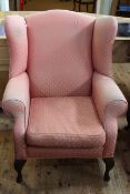 Wing armchair on cabriole legs.