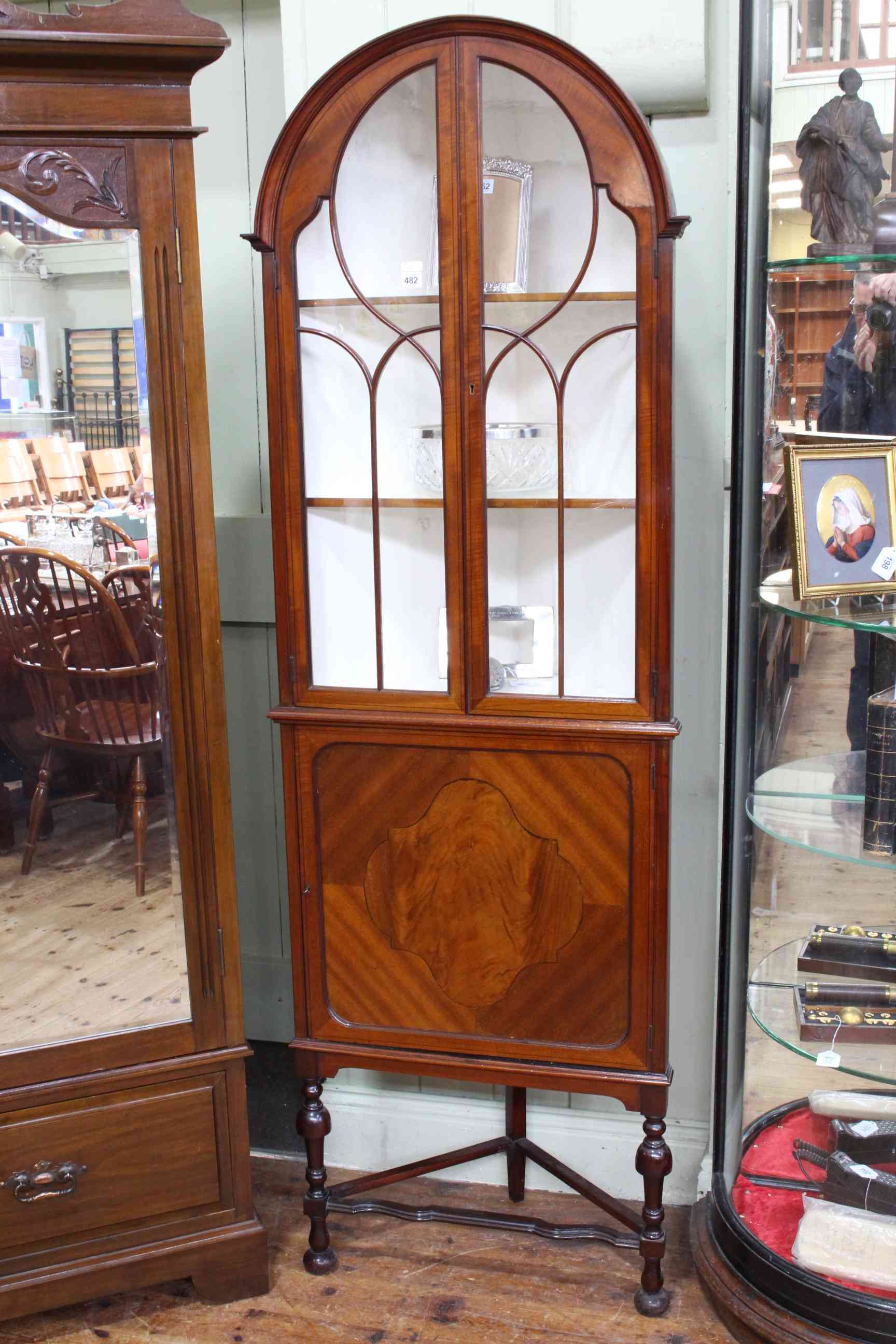 Edwardian mahogany and ebony line inlaid corner cabinet having two arched glazed panel doors above