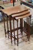 Nest of three Edwardian mahogany and satinwood inlaid tables of serpentine form (largest 71cm by
