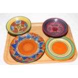 Tray lot with eight pieces of Clarice Cliff and similar plates and tazza.