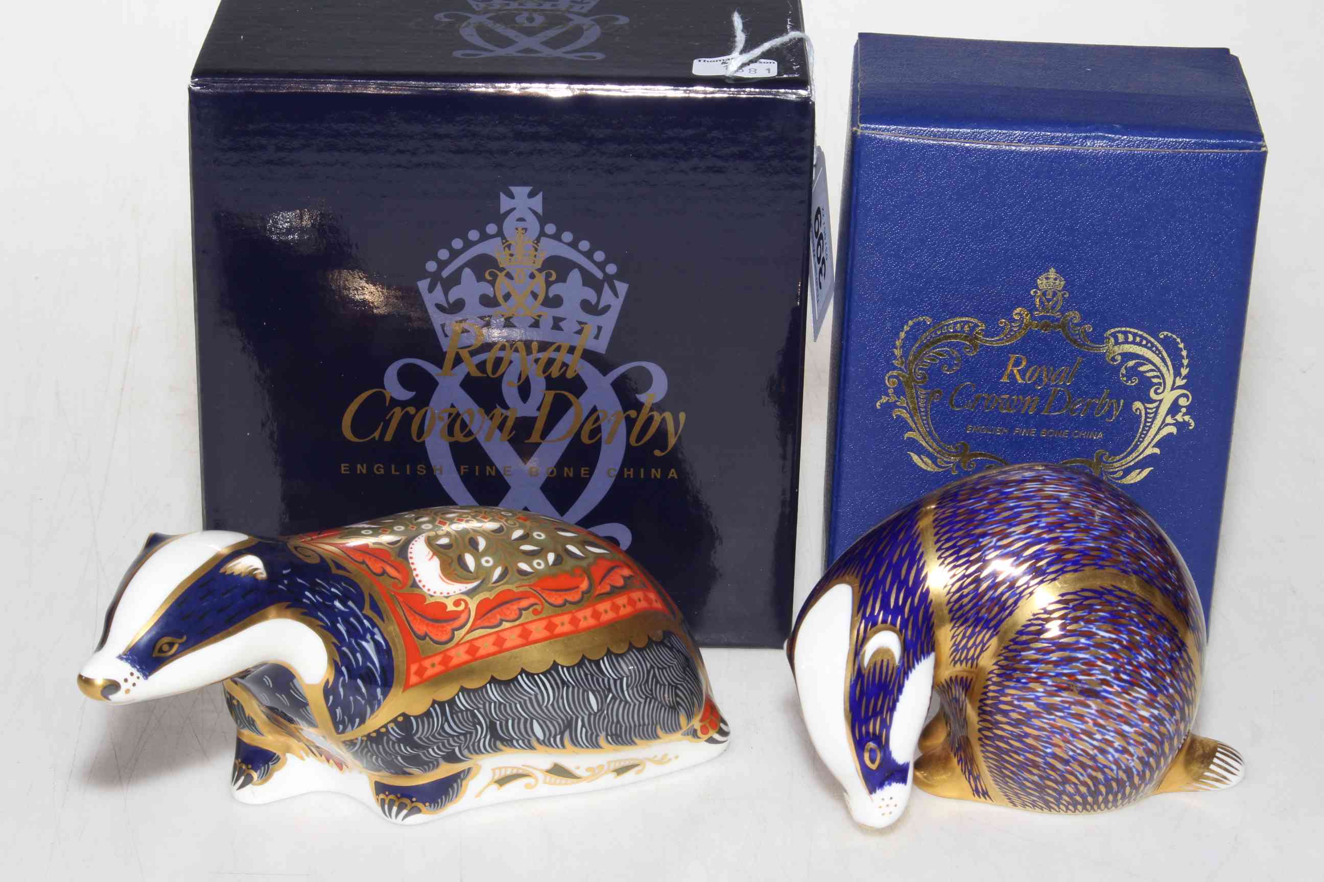 Two Royal Crown Derby paperweights, Moonlight Badger and another Badger.