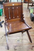 Victorian pitch pine ecclesiastical X-framed chair.