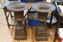 Pair cast Campana style garden urns on stepped bases, 87cm by 47cm diameter.