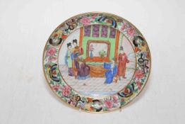 Chinese porcelain plate decorated with figure in interior scene with floral border.