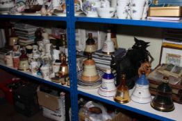 Collection of Bells whisky bottles, pub mirrors, matchboxes, wooden cabinet, commemorative wares,