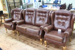 Sherbourne tan buttoned leather wing two seater three piece lounge suite.