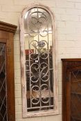 Arched top and wrought iron rectangular framed wall mirror, 123cm by 40cm.