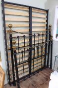 Victorian style black and brass double bedstead.