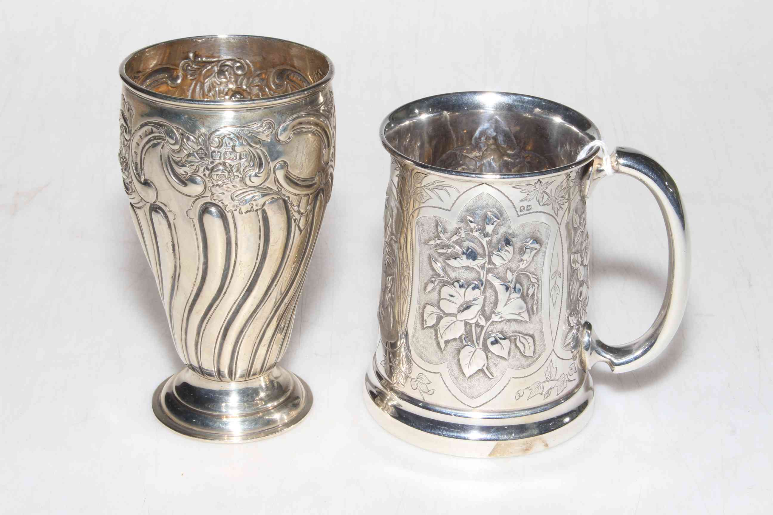 Late Victorian embossed silver vase, Sheffield 1899 and Victorian floral embossed silver tankard,