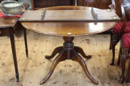 Period style circular oak extending table and leaf on turned pedestal to four scrolling legs,