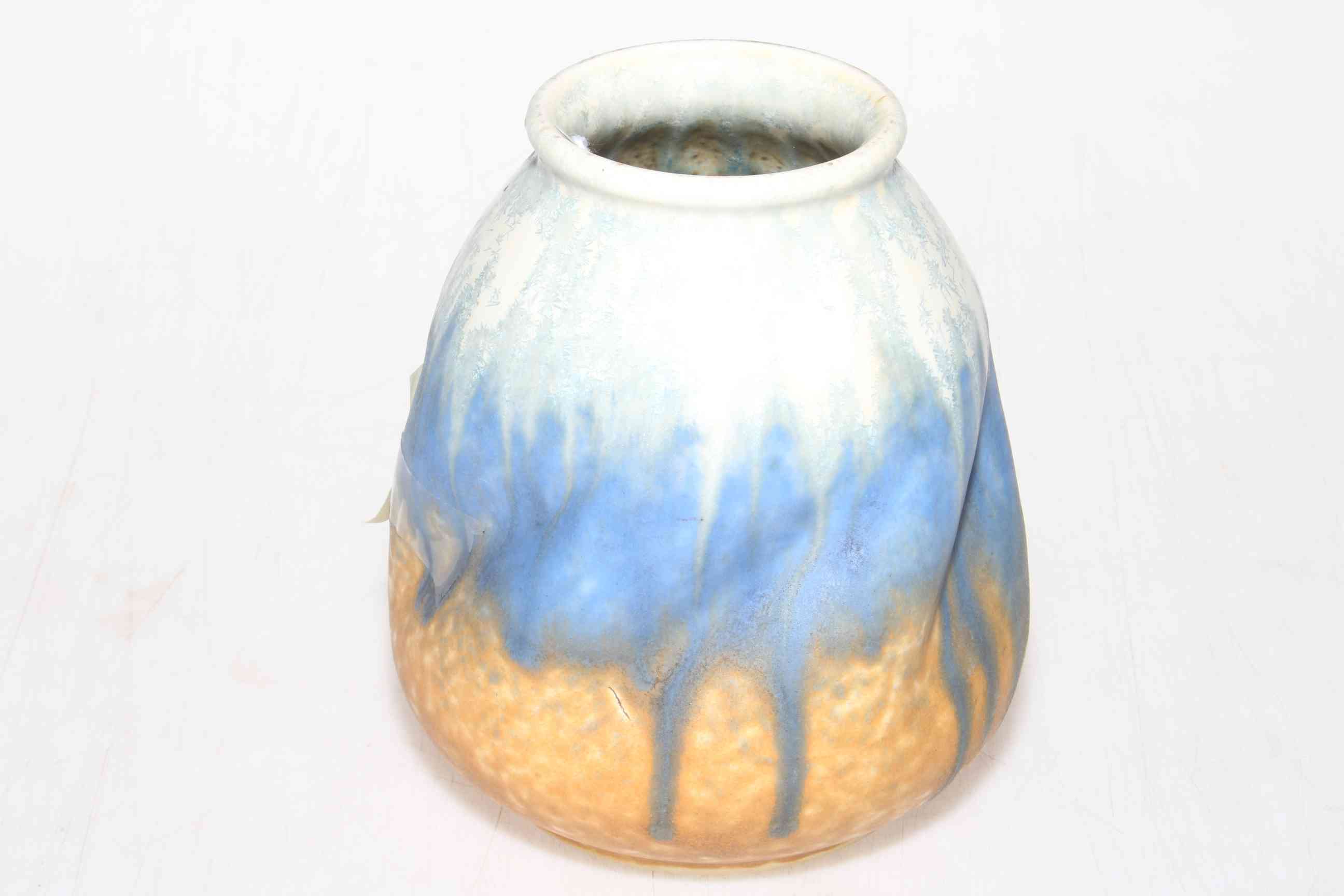Ruskin Pottery dimple bodied vase with blue/orange drip design, 14cm high.