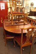 Twin pedestal extending dining table and two leaves together with a set of eight Chippendale style