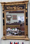 Regency style black and gilt framed bevelled wall mirror, 116.5cm by 88cm.