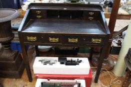 Late 19th Century oak desk having four small drawers and three open compartments above a leather