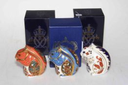 Three Royal Crown Derby paperweights including grey, blue and red Squirrels, with boxes.