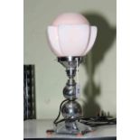 Art Deco style table lamp with pink shade.