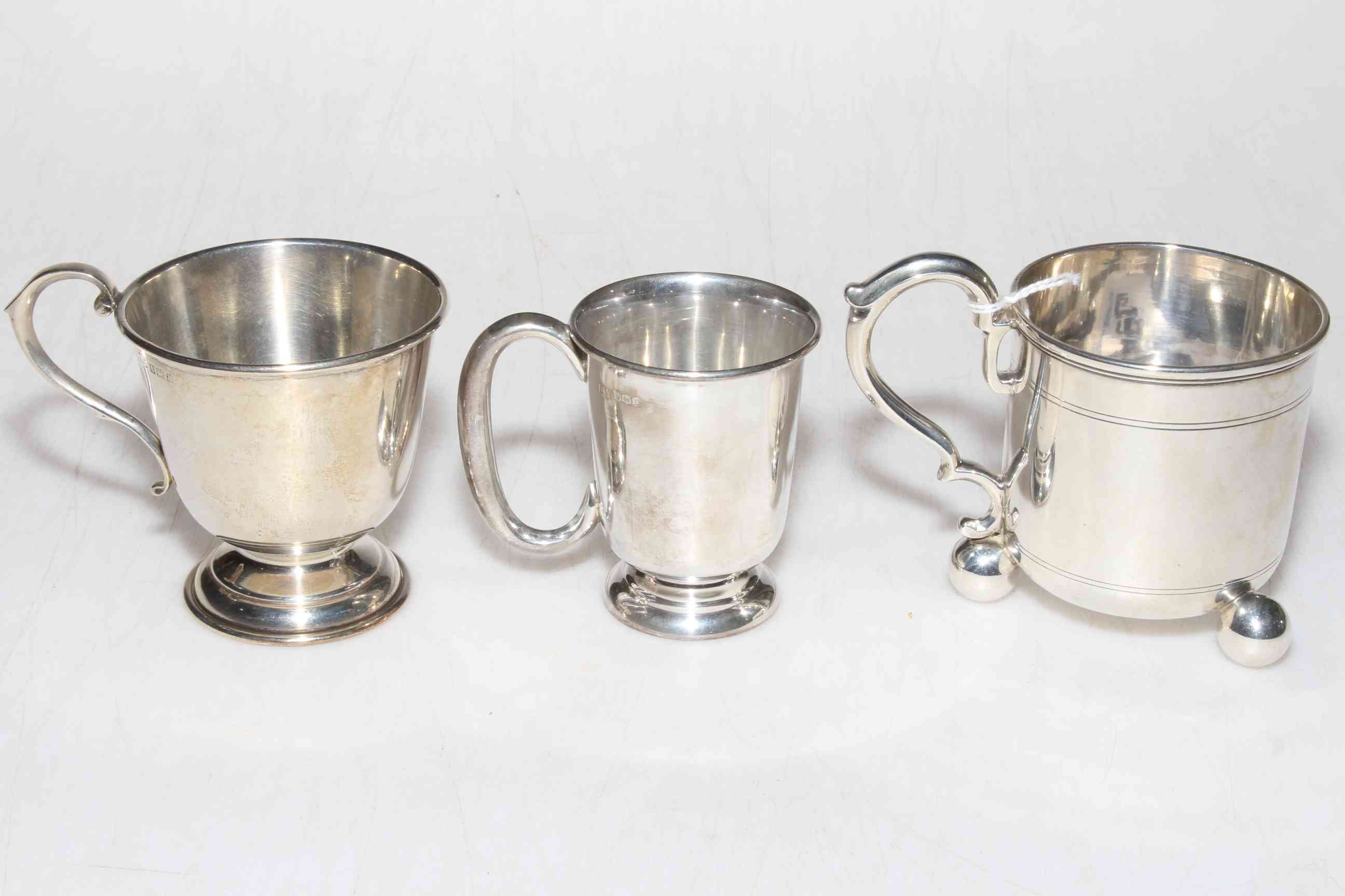 Victorian silver tankard raised on three ball feet, London 1873 and two small silver cups.