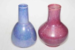 Two Ruskin Ware vases in pink and blue glazes, 21cm high.