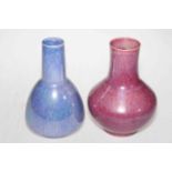 Two Ruskin Ware vases in pink and blue glazes, 21cm high.