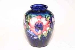 Moorcroft Pottery vase decorated with anemone on blue ground, 16.5cm.