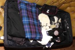 Tartan kilt with accessories in bag.