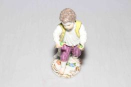 Meissen figure of boy holding birds.